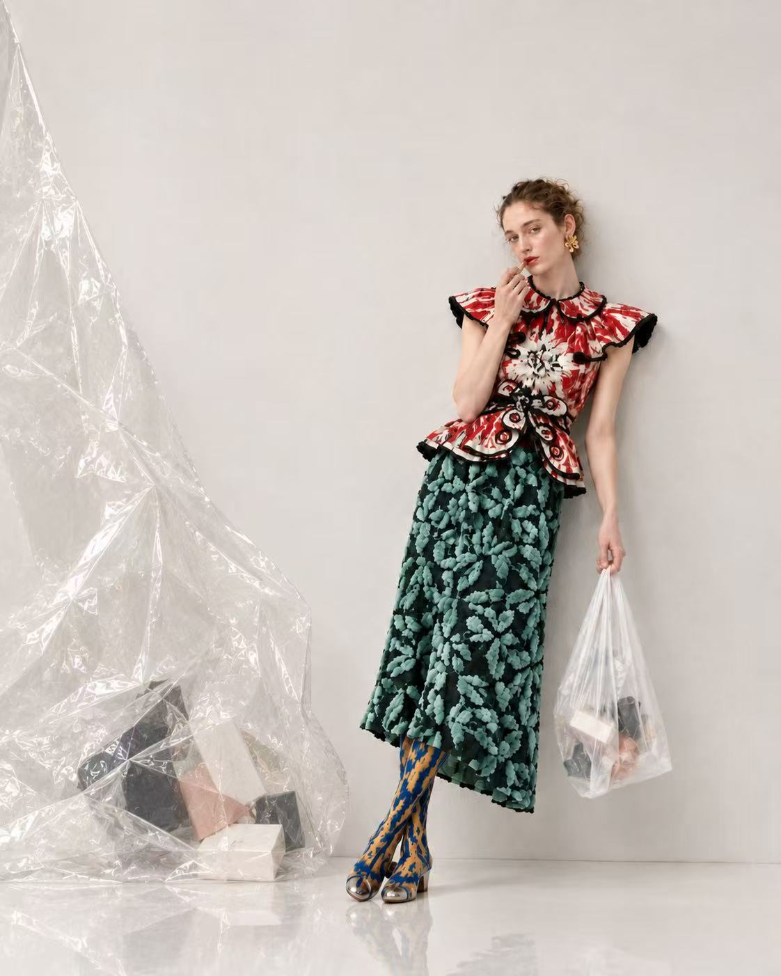 Fashion campaign featuring a model with a translucent plastic bag